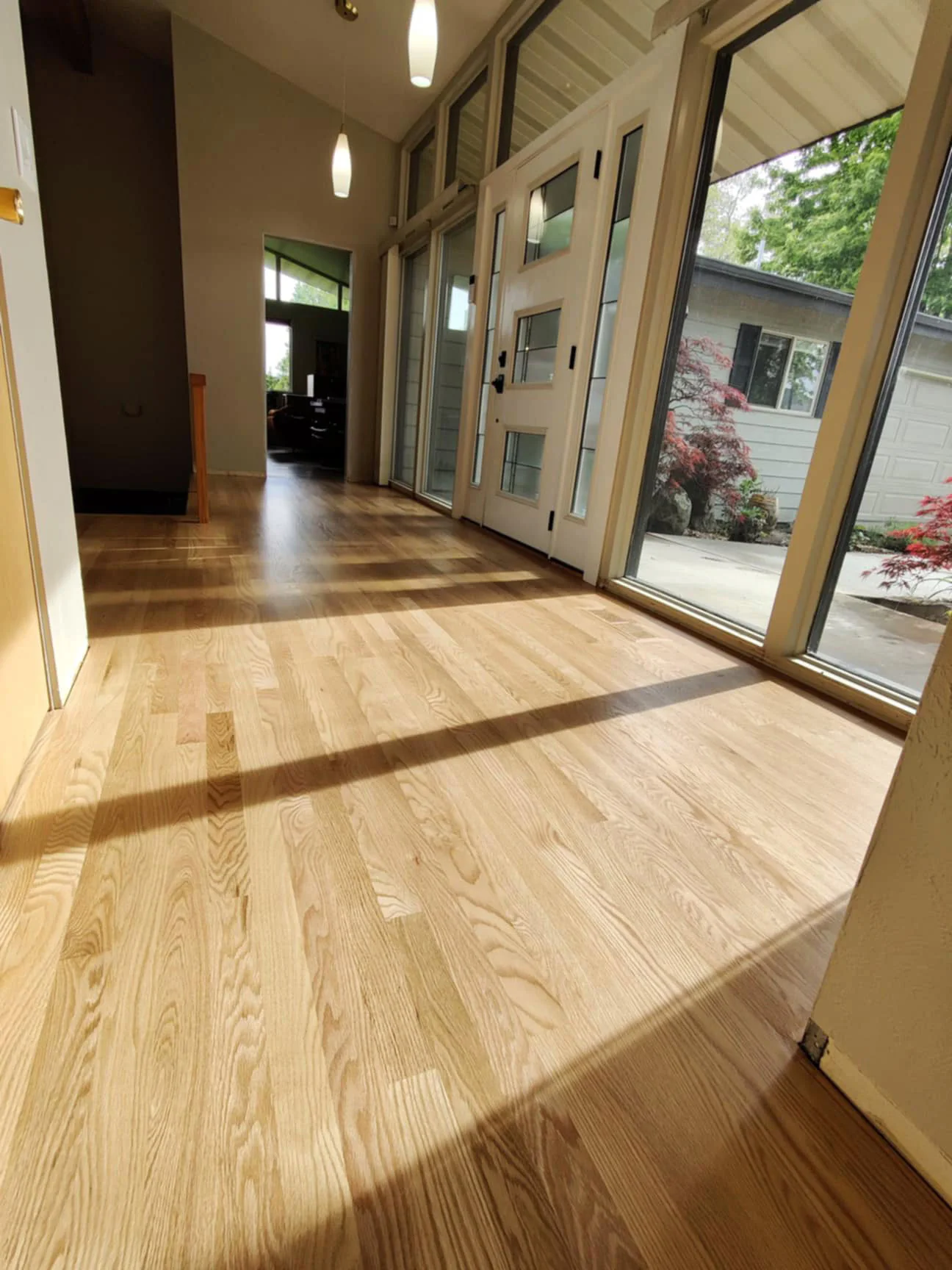 Solid red oak strip flooring with neutral sealer.